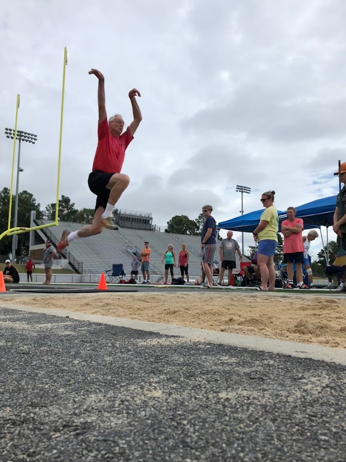 A man running in a track and field event.